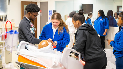 ASPIRE students treating a simulated patient.