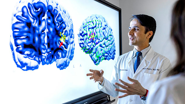 Neurologist reviewing brain scans.
