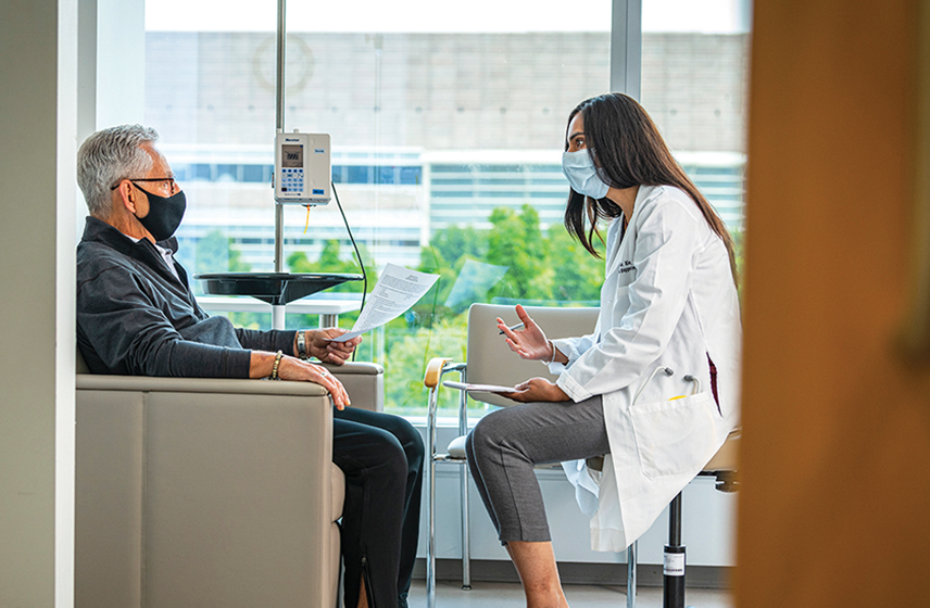 Doctor and patient sitting down and having a conversation.