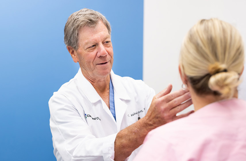 Cleveland Clinic doctor feeling the neck of a patient.