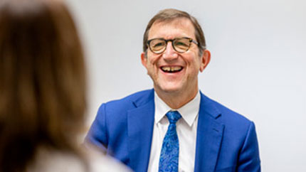 Dr. Robert Saper talking and laughing with a patient.