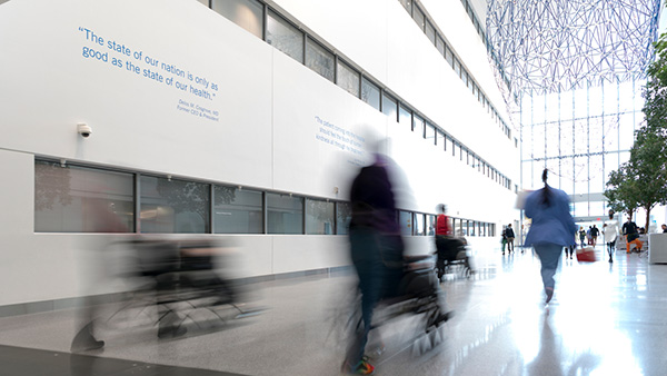 blurry patients walking through Glickman lobby