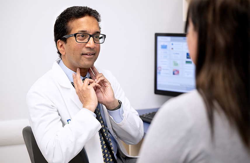 Doctor talking to a patient in a medical examination office.
