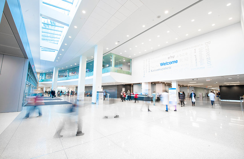 A long exposure image of Cleveland Clinic's entryway. A welcome sign in multiple languages is visible.